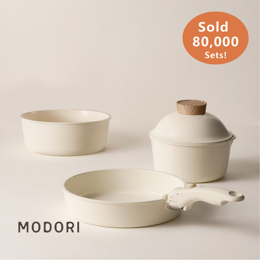 Modori Sodam Cookware Set is a stackable and detachable handle 3-piece cookware set that allows you to organize your kitchen space easily. Made of 98% pure aluminium alloy and natural mineral sand ceramic composition. You can use them on gas cooktops, induction cooktops, IH cookware, black ceramic cookware, and ovens.  Sodam collection has a practical design and minimalist colours that will suit any kitchen. Modori is the key to designing your dream kitchen.
